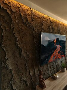 Vulkanikus kőhatású, kézzel készített sziklafal minimalista stílusú médiafal részeként